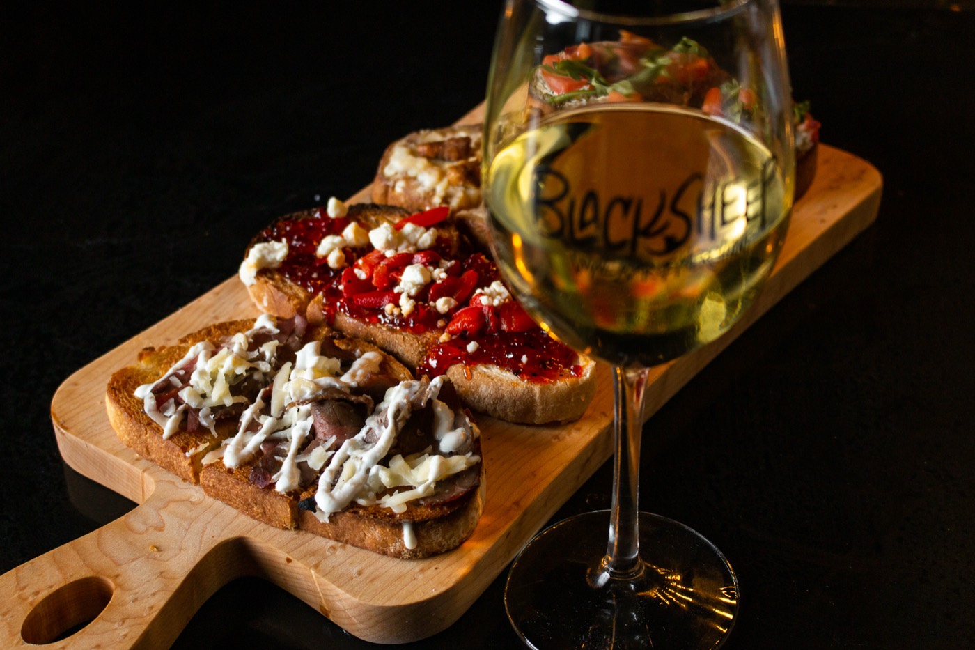 BlackSheep bruschetta and a branded glass of white wine